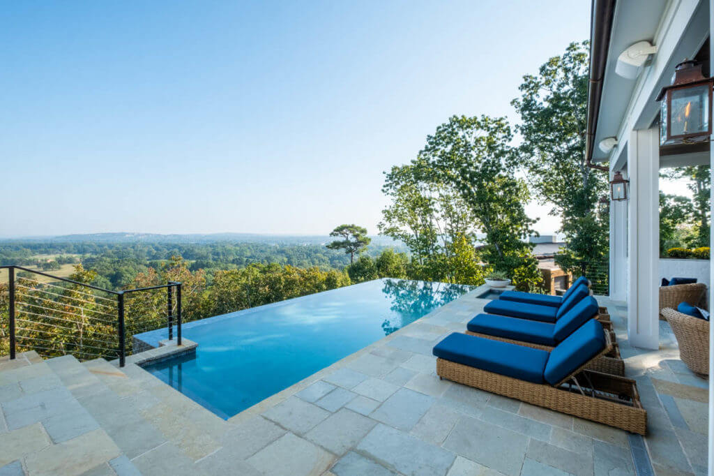 Sharp rectangular infinity pool and patio overlooking a lush Little Rock countryside